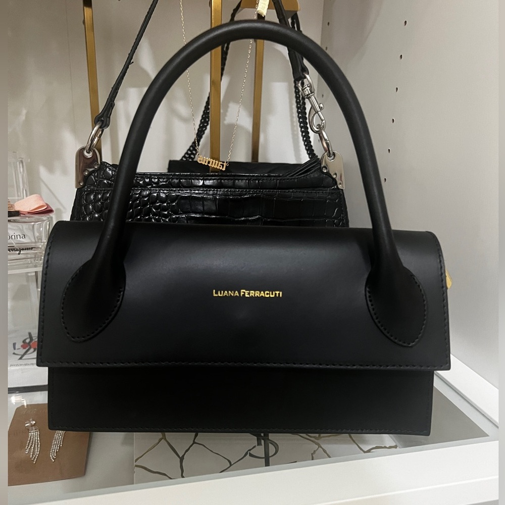 LUANA FERRACUTI black leather bag with golden hardware, featuring a zip closure